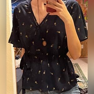 small blue pineapple blouse with a tie on the side. button to adjust the v neck